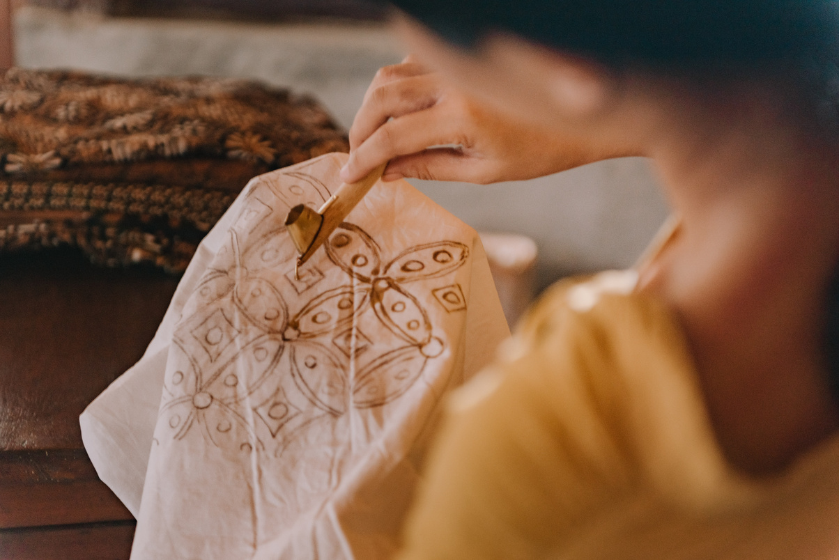 Woman Drawing Batik Pattern on Cloth with Dye 