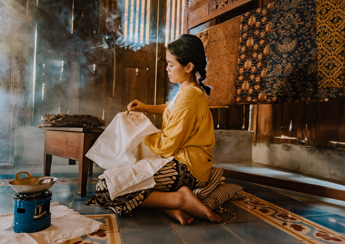 Woman Drawing Batik Pattern on Cloth with Dye 